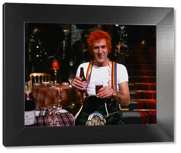 Russ Abbot comedian November 1994 dressed as Jimmy wearing kilt holding bottle of beer