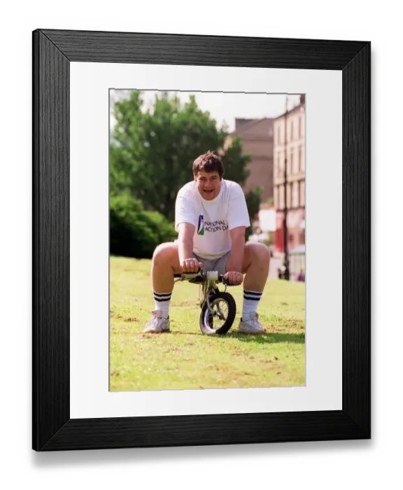 Framed Print : Gordon kennedy tv presenter sitting on a tiny bike at the kelvin sports arena Framed Print : Gordon kennedy tv presenter sitting on a tiny bike at the kelvin sports arena