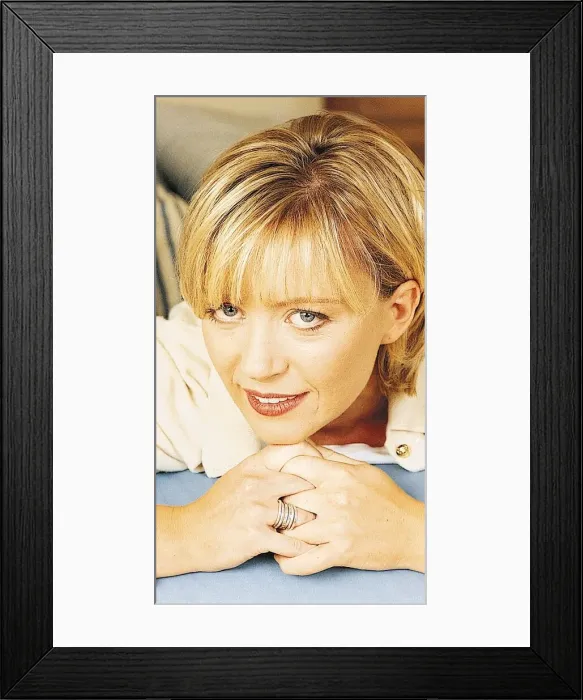Framed Print : TV presenter Kirsty Young lying with chin on clasped hands