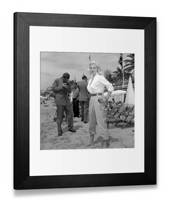 Framed Print : Actress Diana Dors has her picture taken by a photographer on the beach at cannes Film