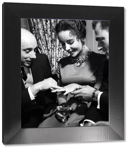 Elizabeth Taylor with Husband Mike Todd showing off diamond ring to Donald Zec