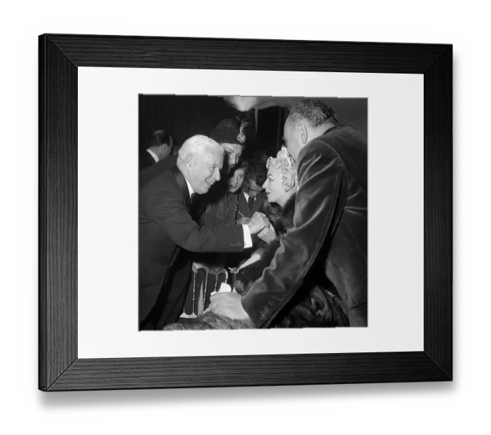 Framed Print : Charlie Chaplin talking with Madame Grund wife of French publisher at the Ice Ball in
