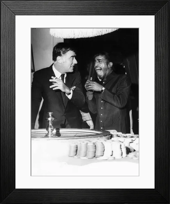 Framed Print : Sammy Davis Jnr Actor / Singer with Peter Lawford at gambling tables at the Pair of Shoes Framed Print : Sammy Davis Jnr Actor / Singer with Peter Lawford at gambling tables at the Pair of Shoes