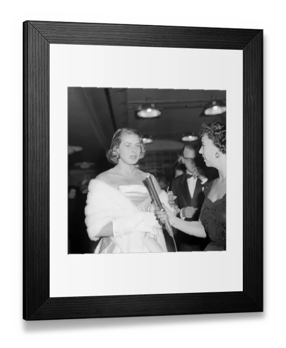 Framed Print : Ingrid Bergman wearing a satin dress and fur stole at the premiere of a film November