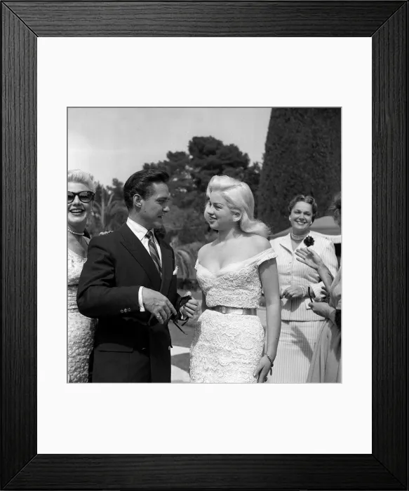Framed Print : Actress Diana Dors chatting with Richard Todd at the Cannes film Festival