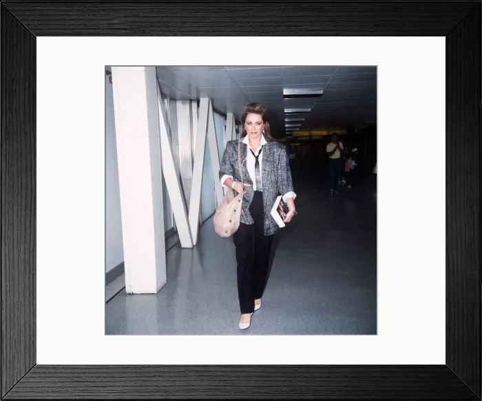 Framed Print : Jackie Collins arriving at Heathrow with her new book September 1985 Framed Print : Jackie Collins arriving at Heathrow with her new book September 1985