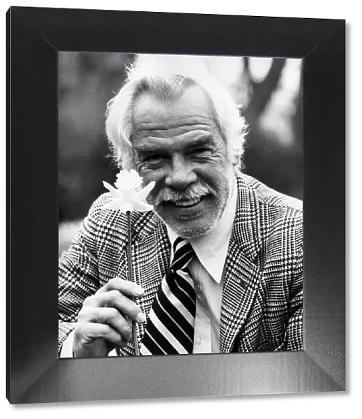 Lee Marvin American actor holding daffodil 1975
