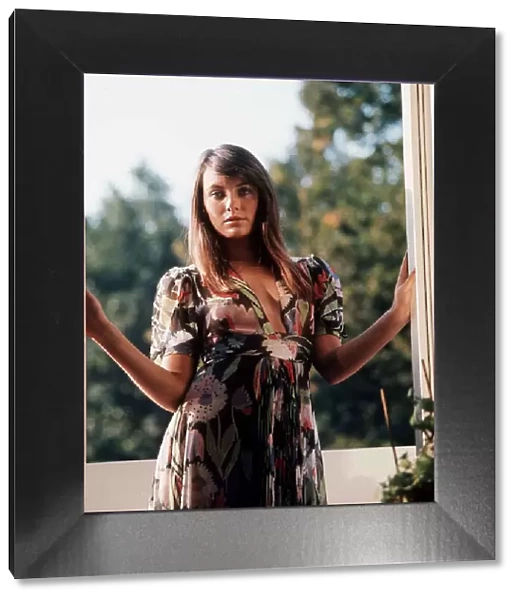 Actress Lesley Ann Down standing at a window 1974