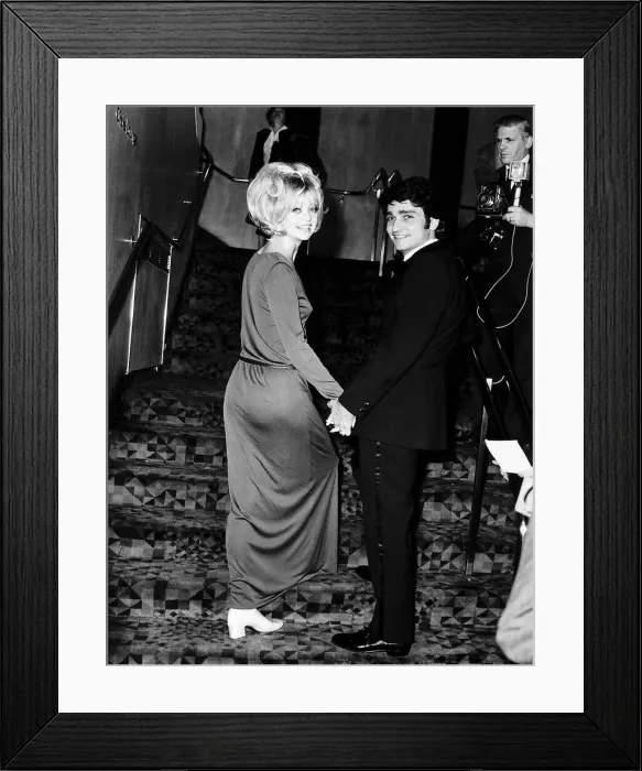Framed Print : Goldie Hawn Actress holding hands with her husband Gus Trikonis at a film premiere in Framed Print : Goldie Hawn Actress holding hands with her husband Gus Trikonis at a film premiere in