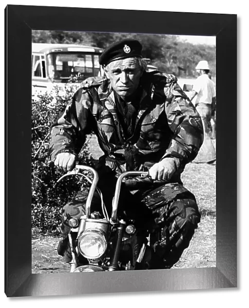 Richard Harris Irish actor on set of film Wild Geese 1977 riding motorcycle in army