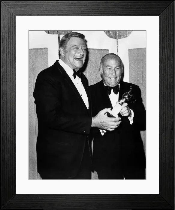 Framed Print : Hal Wallis film producer accepts Cecil B De Mille award 1975 from actor John Wayne