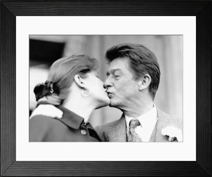 Framed Print : John Hurt British film actor kisses his new bride 1990
