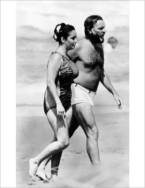 Actress Elizabeth Taylor and husband Richard Burton on the beach