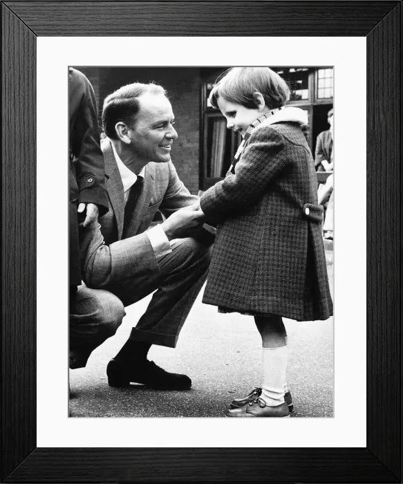 Framed Print : Frank Sinatra Actor and Singer talking to a little blind girl at his visit to Framed Print : Frank Sinatra Actor and Singer talking to a little blind girl at his visit to