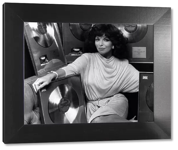 Joan Collins actress presented with A Golden Record to celebrate sales in the UK