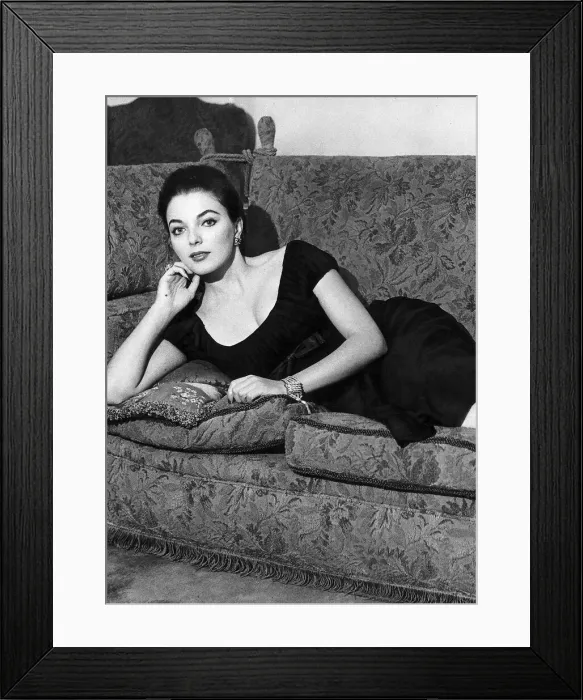 Framed Print : Actress Joan Collins poses on her sofa June 1956 Framed Print : Actress Joan Collins poses on her sofa June 1956