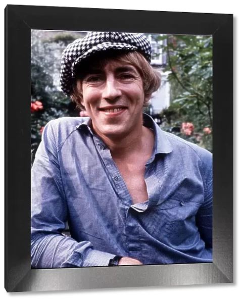 Peter Cook actor at home in his garden wearing a hat
