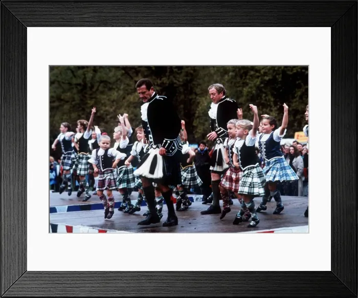 Framed Print : Roger Moore with Michael Caine dancing with children November 1989 Framed Print : Roger Moore with Michael Caine dancing with children November 1989