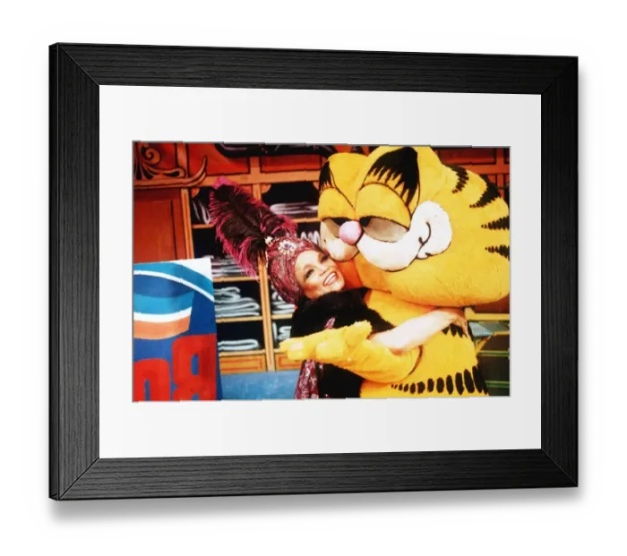 Framed Print : Eartha Kitt Actress hugs Garfield at a Xmas Party December 1989 Framed Print : Eartha Kitt Actress hugs Garfield at a Xmas Party December 1989