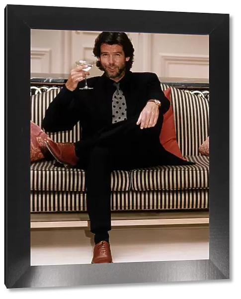 Pierce Brosnan Actor with a glass of Champagne
