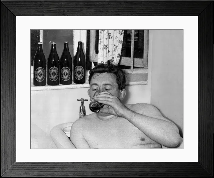 Framed Print : A man relaxes in the bath drinking a bottle of beer September 1955 Framed Print : A man relaxes in the bath drinking a bottle of beer September 1955
