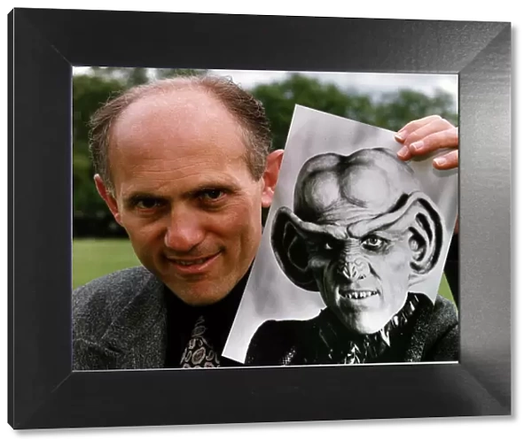 Armin Shimerman American Actor Holding A Picture Of Quark Who He Stars As In Star Trek