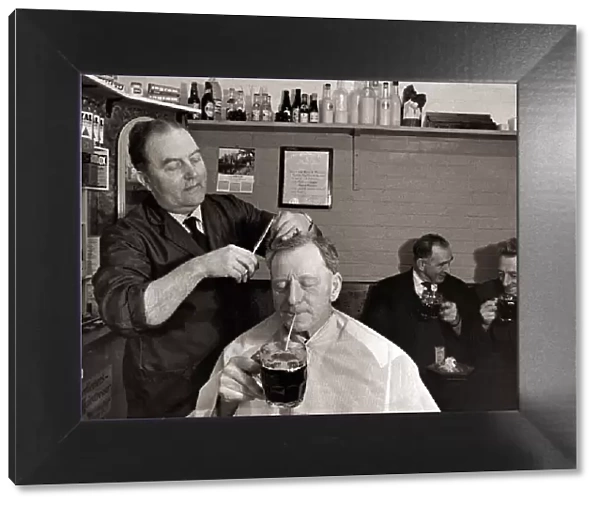 The landlord of the Railway Inn, Bernard Fabian cuts hair in between pulling pints in