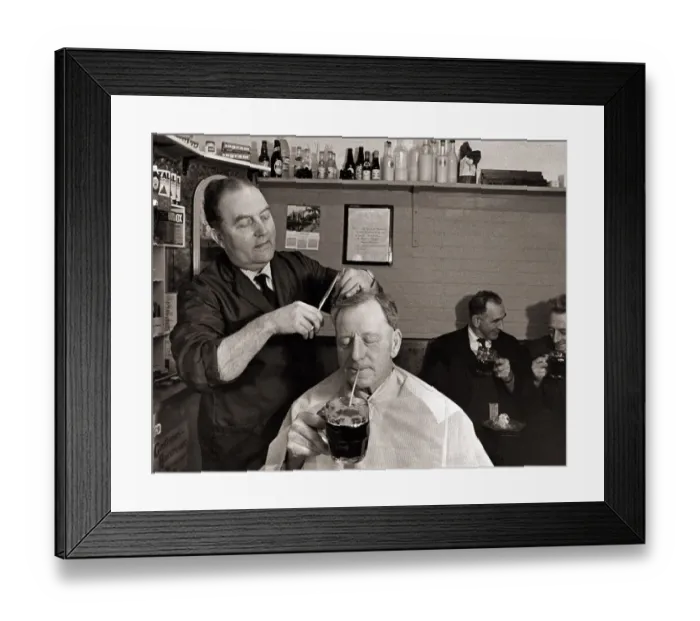 Framed Print : The landlord of the Railway Inn, Bernard Fabian cuts hair in between pulling pints in Framed Print : The landlord of the Railway Inn, Bernard Fabian cuts hair in between pulling pints in