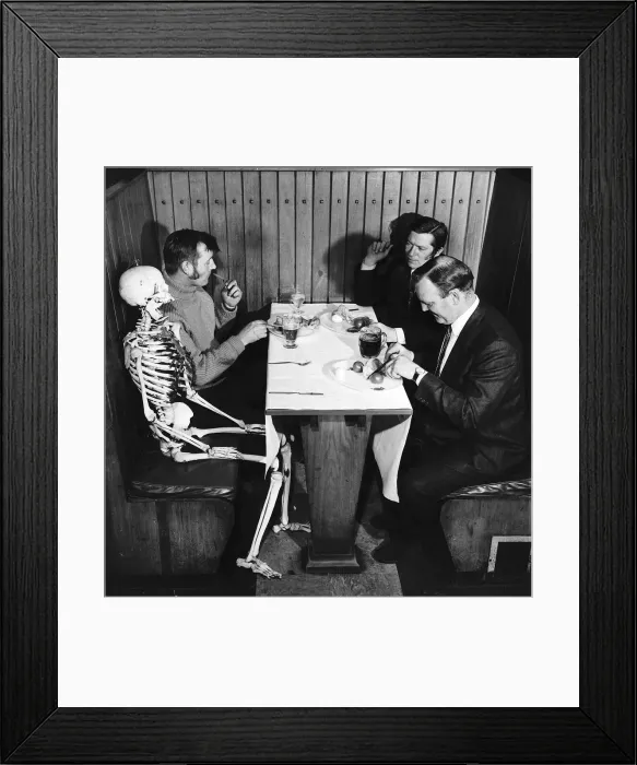 Framed Print : Skeleton sits at table in pub waiting to be served Framed Print : Skeleton sits at table in pub waiting to be served