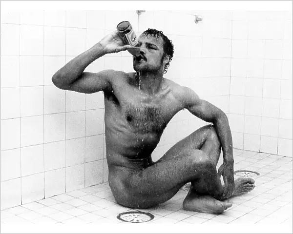 Boxer John Conteh drinking beer in the shower December 1978