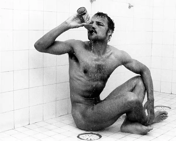 Boxer John Conteh drinking beer in the shower December 1978
