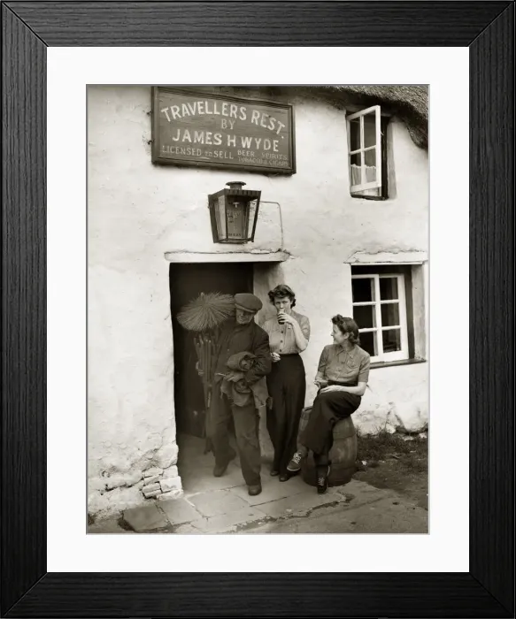 Framed Print : A chimney sweep passes two land girls enjoying a well earnt break from their toil in Framed Print : A chimney sweep passes two land girls enjoying a well earnt break from their toil in