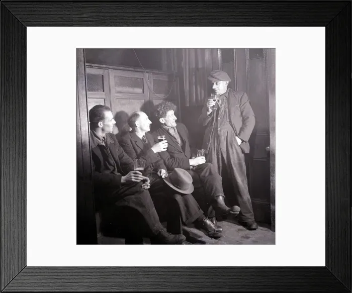 Framed Print : Work mates sit in the snug and enjoy a cigarette and a pint of beer following a hard days