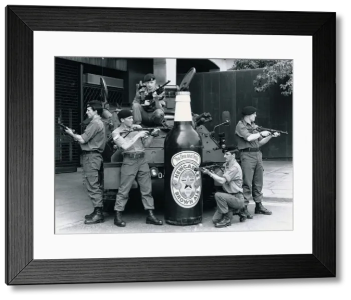 Framed Print : British troops guarding a 6 foot tall bottle of Newcastle brown ale standing in front of