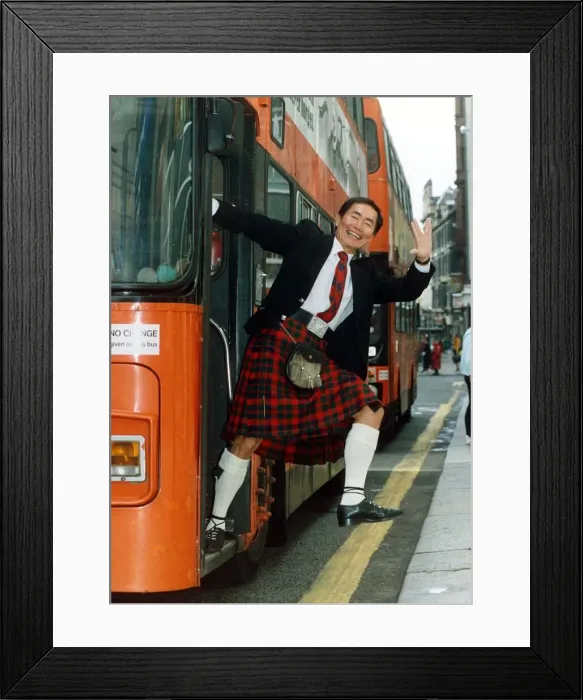 Framed Print : George Takei July 1992 stepping off a bus, wearing traditional Scottish clothing Framed Print : George Takei July 1992 stepping off a bus, wearing traditional Scottish clothing