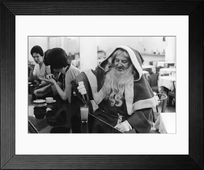 Framed Print : Father Christmas having a drink in a cafe bar in Paris