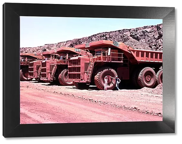 Series of large haul packs iron ore mine at Mount Newman in Western Australia