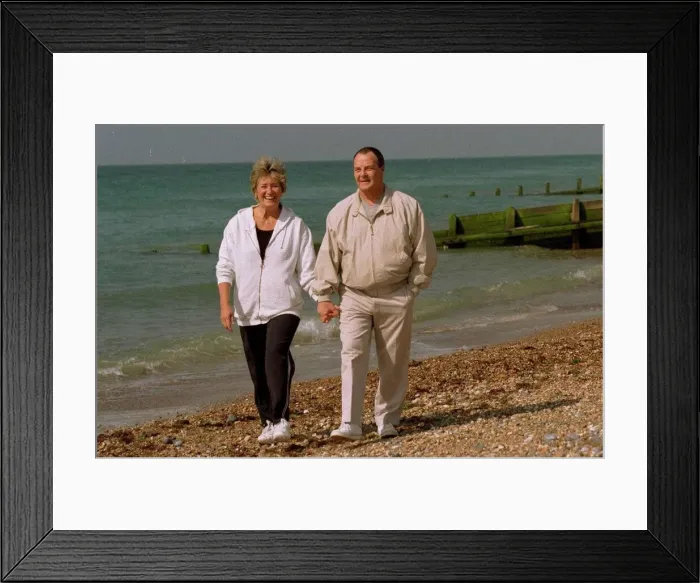 Framed Print : Brian Hill Actor who played the part of the chef in Fawlty Towers walking on the beach
