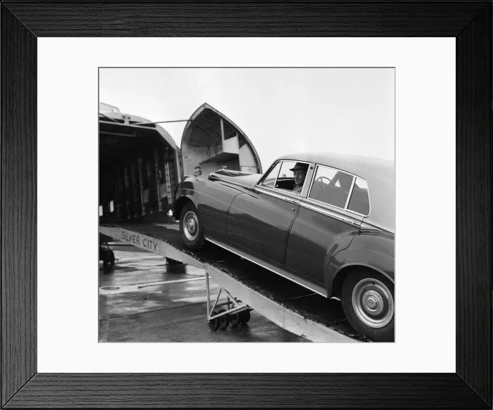 Framed Print : Actor Alec Guinness loading his Bently onto an aircraft bound for France where he will Framed Print : Actor Alec Guinness loading his Bently onto an aircraft bound for France where he will