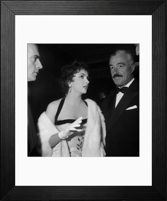 Framed Print : Italian film stars Gina Lollobrigida and Vittorio De Sica at the opening premiere of