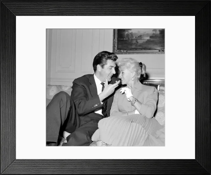 Framed Print : Film actress Ginger Rogers with David Hughes sitting on a couch together May