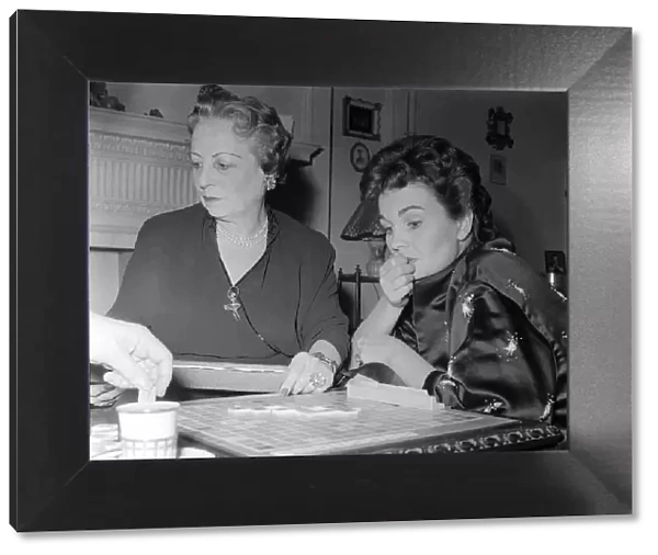 Actress Jean Simmons, right, with her former teacher Ada Foster playing a game of