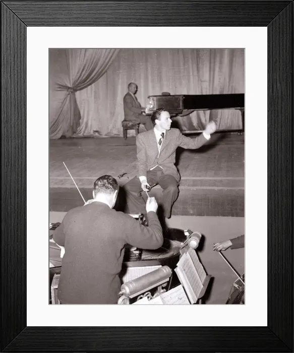 Framed Print : American singer and film star Frank Sinatra sitting on stage during rehearsals Framed Print : American singer and film star Frank Sinatra sitting on stage during rehearsals