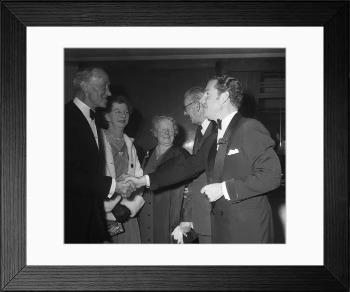 Framed Print : Actor Kenneth More shakes hands with Mrs E Daniels of Portsmouth who was a survivor of Framed Print : Actor Kenneth More shakes hands with Mrs E Daniels of Portsmouth who was a survivor of
