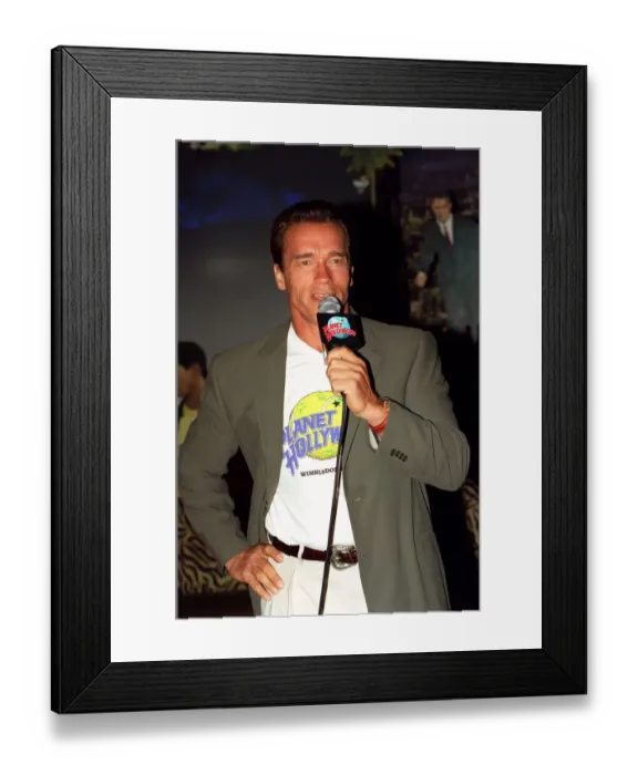 Framed Print : Arnold Schwarzenger Actor July 98 At Planet Hollywood restaurant in london holding Framed Print : Arnold Schwarzenger Actor July 98 At Planet Hollywood restaurant in london holding