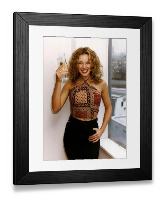 Framed Print : Kylie Minogue Singer Actress has a glass of champagne after signing a new contract at RCA Framed Print : Kylie Minogue Singer Actress has a glass of champagne after signing a new contract at RCA