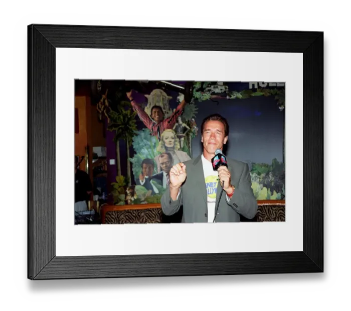 Framed Print : Arnold Schwarzenger Actor July 98 At Planet Hollywood restaurant in london holding Framed Print : Arnold Schwarzenger Actor July 98 At Planet Hollywood restaurant in london holding