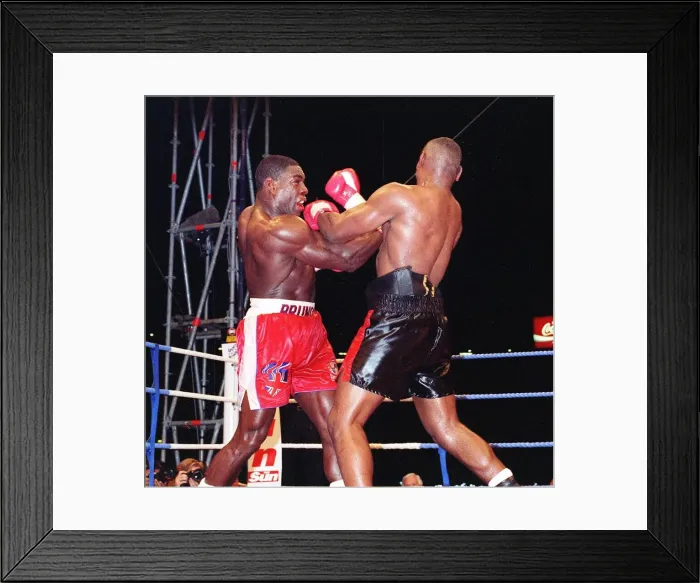 Framed Print : Frank Bruno lands another punch to the head of Oliver McCall in his WBC championship Framed Print : Frank Bruno lands another punch to the head of Oliver McCall in his WBC championship