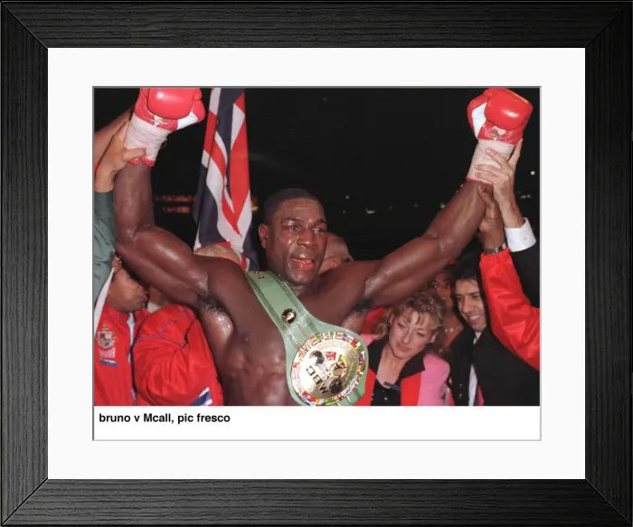 Framed Print : Frank Bruno raises his arms in jubilation after defeating Oliver McCall at Wembley