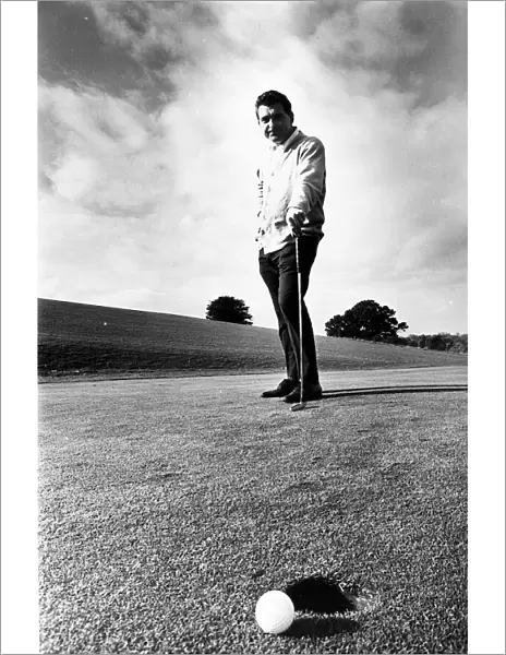 David Lewis Nov 1967 golf professional at East Hert golf club contemplates missed putt